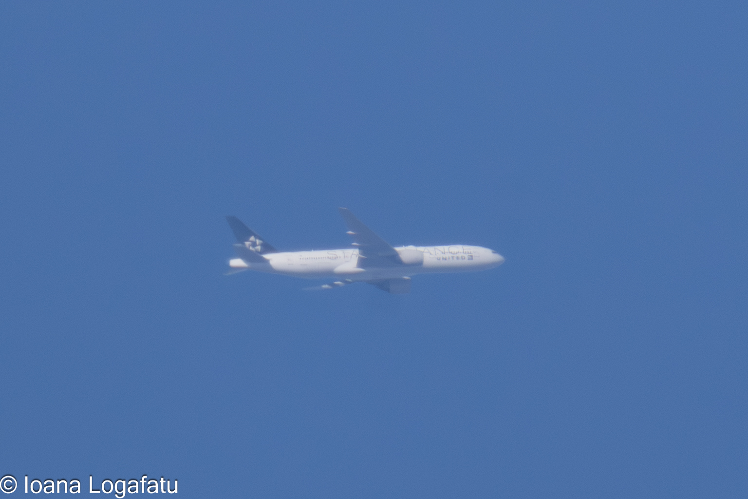 Aircraft gliding through a clear blue sky